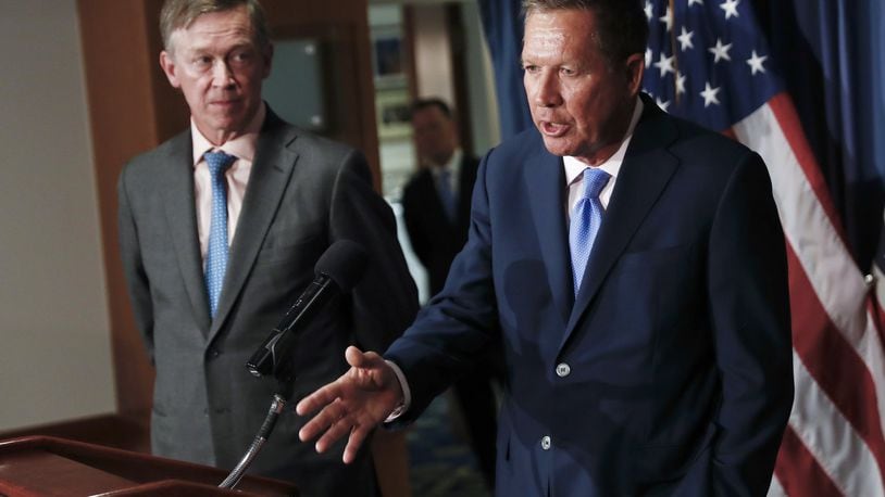 In this June 27, 2017, file photo, Ohio Gov. John Kasich, right, is joined by Colorado Gov. John Hickenlooper during a news conference at the National Press Club in Washington. The bipartisan governor duo is urging Congress to retain the federal health care law’s unpopular individual mandate while seeking to stabilize individual insurance markets. (AP Photo/Carolyn Kaster, file)