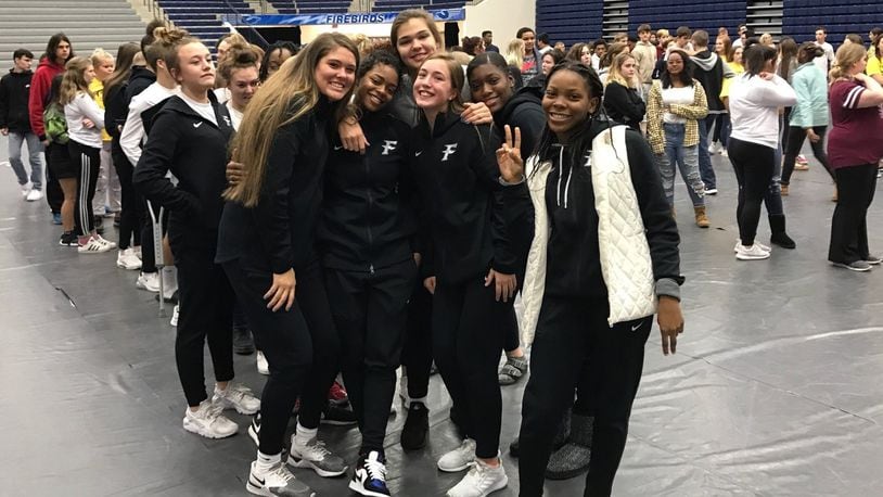 Fairmont teammates embrace Makira Webster (second from left ) after she gave a powerful speech on the troubling things she has endured past two years to Fairmont students last Friday at the school. Tom Archdeacon/CONTRIBUTED