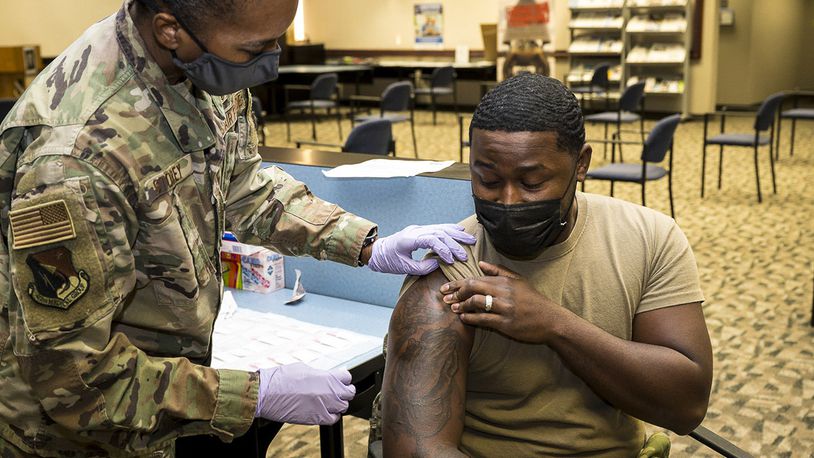 Senior Airman Rendall Powell, 412th Test Wing, receives a COVID-19 vaccination shot from Lt. Col. Yvonne Storey, 412th Medical Group, at the Airman and Family Readiness Center on Edwards Air Force Base, California, Aug. 25. U.S. AIR FORCE PHOTO/KATHERINE FRANCO