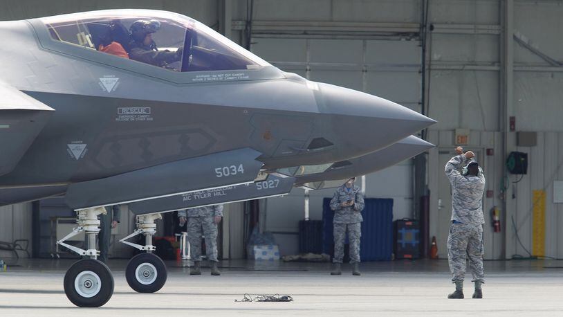 An F-35 pilot and ground crewmember at the Vectren Dayton Air Show. TY GREENLEES / STAFF FILE PHOTO