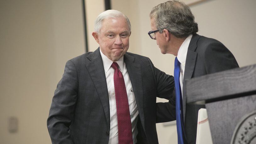 Attorney General Jeff Sessions hugs Mike DeWine, Ohio Attorney General, before speaking on the opioid epidemic at The Columbus Police Academy on August 2, 2017 in Columbus, Ohio. Since taking office, Sessions has taken steps to advance a more aggressive, hard line in federal drug policy. (Photo by Maddie McGarvey/Getty Images)