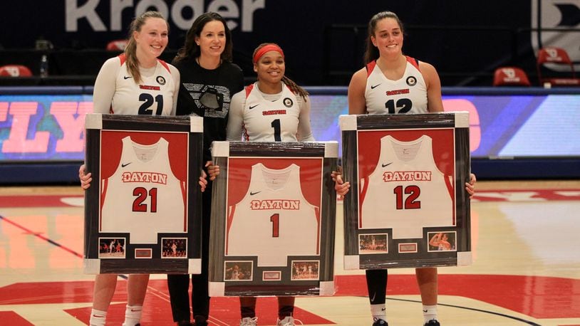 Dayton coach Shauna Green poses for a photo with seniors Erin Whalen, Araion Bradshaw and Jenna Giacone after a game against Saint Louis on Saturday, Feb. 20, 2021, at UD Arena. David Jablonski/Staff