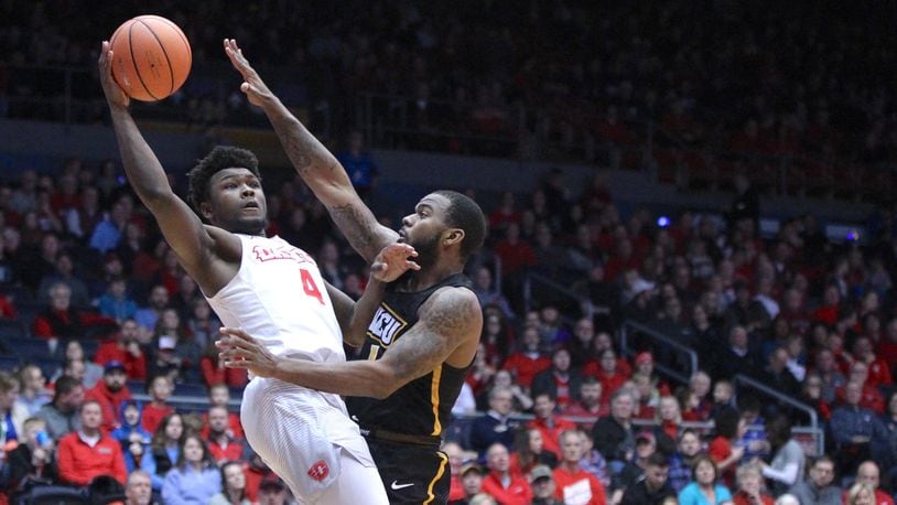 Dayton’s Jordan Davis scores and is fouled by Virginia Commonwealth’s Mike’l Simms on Friday, Jan. 12, 2018, at UD Arena. David Jablonski/Staff