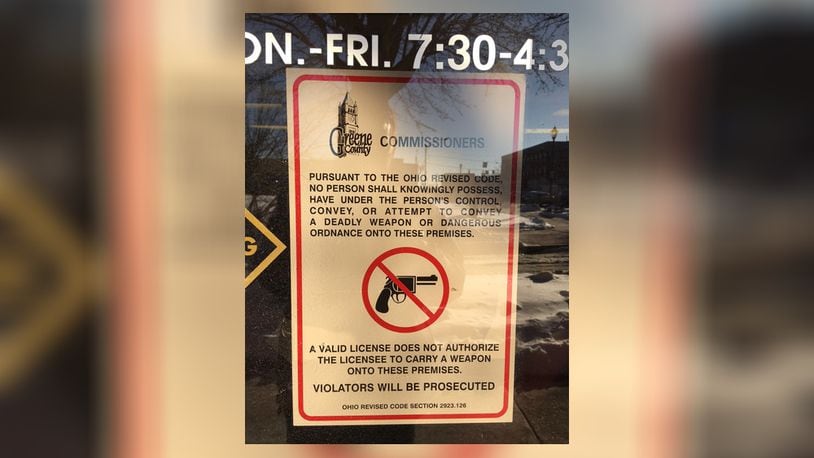 This advisory to concealed-carry permit holders was removed earlier this week from the front door to the Greene County Treasurer's Office following a policy change that loosens the restrictions.