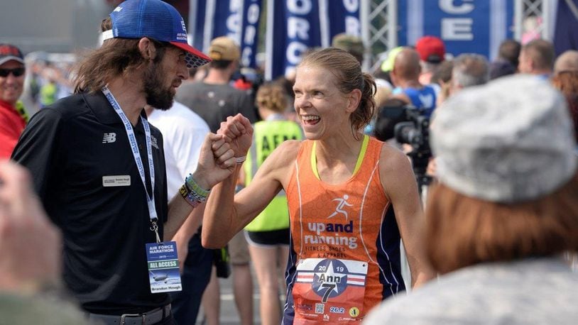 Brandon Hough, Air Force Marathon director, congratulates the full marathon female winner Ann Alyanak from Bellbrook, at the Air Force Marathon at Wright-Patterson Air Force Base, on Sept. 21. (U.S. Air Force photo/Ty Greenlees)