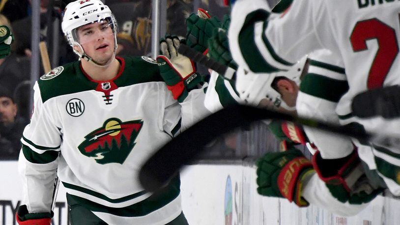 FILE PHOTO: Kevin Fiala #22 of the Minnesota Wild celebrates with teammates on the bench after scoring. Fiala has a new four-legged teammate -- Breezer a service dog-in-training.