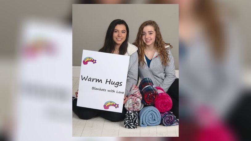 Oakwood eighth-graders Dasha Penas-Johnson (left) and Cecille Figueroa started a Warm Hugs foundation For Hispanic children. CONTRIBUTED