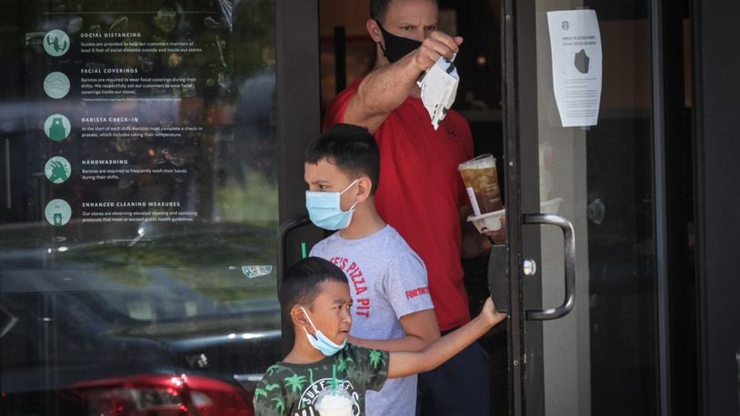 Many large retailers are now requiring that customers join their employees in wearing face masks to stop the spread of the coronavirus. Starbucks, Best Buy and Kroger have also announced mandatory masks nationwide in recent days. Starbucks and Best Buy started requiring that customers wear masks on July 15. Most people who entered the Starbucks on Far Hills Ave. in Oakwood were wearing masks. JIM NOELKER/STAFF