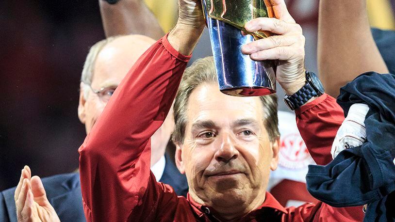 Alabama Crimson Tide head coach Nick Saban raises the  championship trophy at the NCAA National Championship game after midnight on Jan. 9, 2018 in Atlanta, Ga. The Alabama Crimson Tide defeated the Georgia Bulldogs 26-23 in overtime at the Mercedes-Benz Stadium. (Jp Waldron/CSM/Zuma Press/TNS)