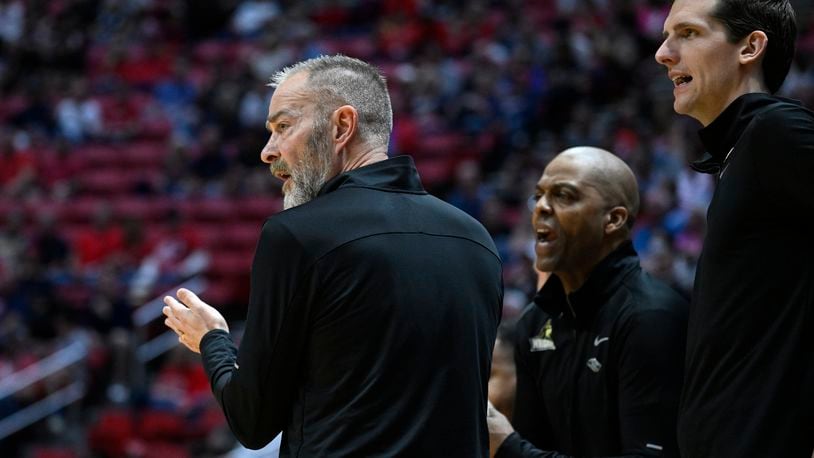 Wright State head coach Scott Nagy, left, stands with assistants by the bench during the first half of a first-round NCAA college basketball tournament game against Arizona, Friday, March 18, 2022, in San Diego. (AP Photo/Denis Poroy)