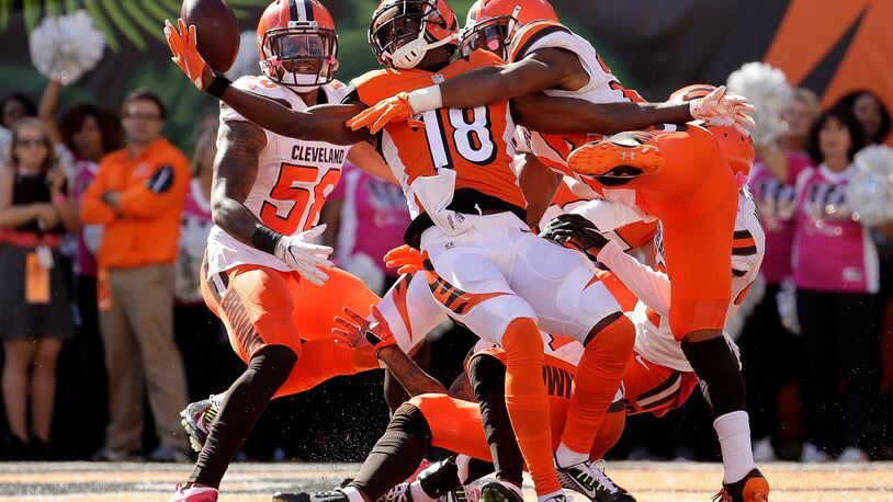 CINCINNATI, OH - OCTOBER 23: A.J. Green #18 of the Cincinnati Bengals catches a hail marry pass for a touchdown at the end of the second quarter of the game while being defended by Ibraheim Campbell #24 of the Cleveland Browns at Paul Brown Stadium on October 23, 2016 in Cincinnati, Ohio. (Photo by Andy Lyons/Getty Images)