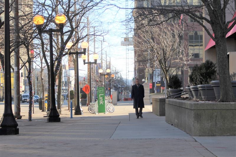 A worker on North Main Street in downtown Dayton on Friday afternoon. CORNELIUS FROLIK / STAFF
