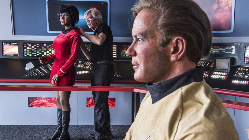 In this Saturday, March 25, 2017 photo, Steve Greenthal adjusts the wax head of Star Trek character Uhura on its body next to a figure of Captain Kirk at the Fullerton Airport in Fullerton, Calif. For many televisions watchers the kiss between Uhura and Kirk was the first interracial kiss seen on TV. The Hollywood Science Fiction Museum recently took possession of wax figures of all seven crew members from the 1960s "Star Trek" TV series. (Nick Agro/The Orange County Register via AP)