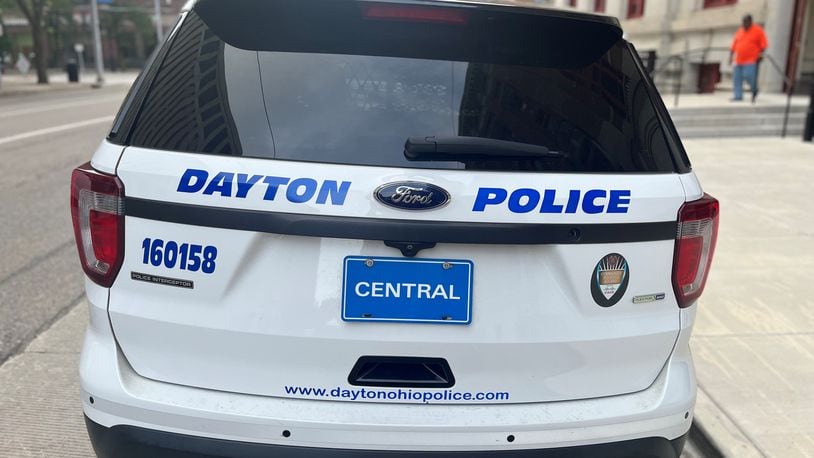 A Dayton Police Department cruiser parked outside of City Hall. CORNELIUS FROLIK / STAFF