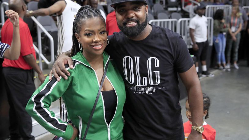 Singer Kandi Burruss and husband Todd Tucker pose together while the 3 Headed Monsters take on Killer 3s during week three of the BIG3 three on three basketball league at State Farm Arena on July 07, 2019, in Atlanta, Georgia. A shooting at the restaurant owned by the couple in East Point, Georgia, injured three on Feb. 14, 2020.