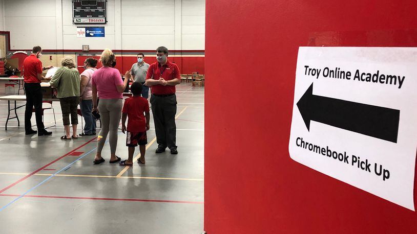 Families in the Troy school district who chose online learning for this fall came to Troy High School on Wednesday, Sept. 2, 2020 to pick up Chromebook computers.