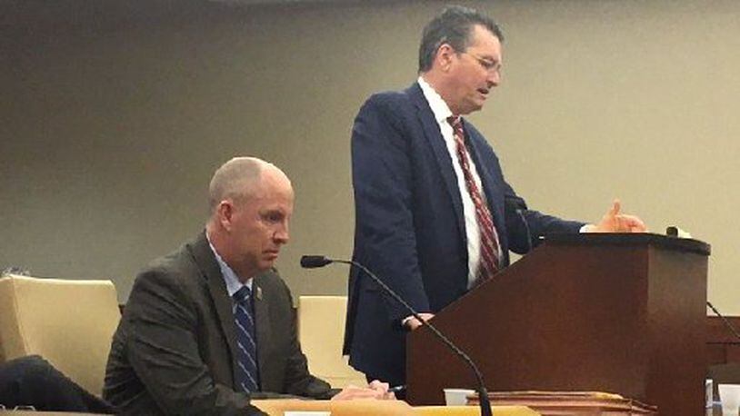 Defense attorney Patrick Mulligan (standing) gives closing statements Monday in a hearing to determine if his 17-year-old client should be tried as an adult in the shooting to death DoubleTree employee Jayren Graham of Miami Twp. Assistant Montgomery County Prosecutor John Amos looks on. NICK BLIZZARD/STAFF