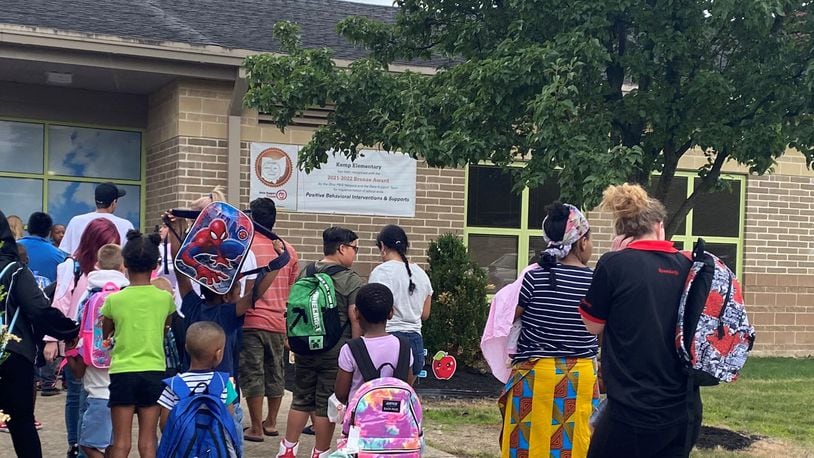 Kids and parents lined up before the first day of school started at Kemp Elementary, part of Dayton Public Schools, on Monday, Aug. 14. Kemp Elementary received 2.5 stars in the 2022-2023 school year report card, higher than the district's overall 2-star rating. Eileen McClory / Staff