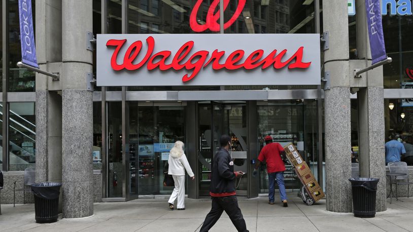 FILE - This June 4, 2014, file photo, shows a Walgreens retail store in Boston. Walgreens and Rite Aid will sell 865 stores to rival retailer Fred’s for $950 million, possibly removing the final roadblock preventing the tie up between the nation’s largest and third-largest drugstore chains, in news announced Tuesday, Dec. 20, 2016. (AP Photo/Charles Krupa, File)