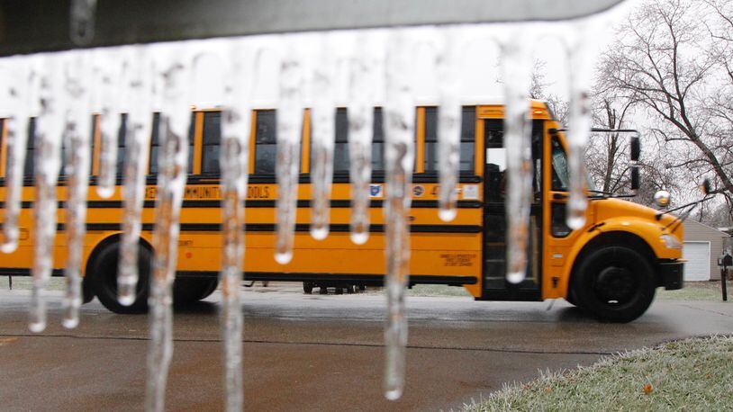 A Xenia school bus returns to the bus barn after a two hour delay and then closing of school due to freezing rain on Thursday. TY GREENLEES / STAFF