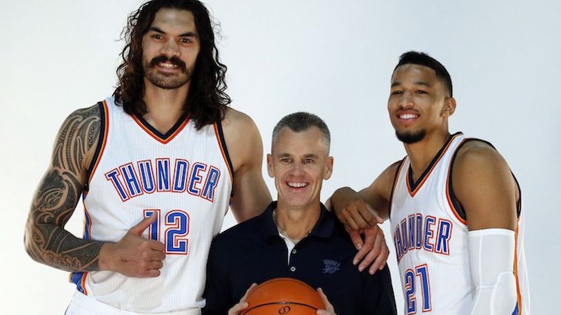 Oklahoma City Thunder head coach Billy Donovan, center, poses for a photo with center Steven Adams, left, and guard Andre Roberson, right, during the 2016-2017 Oklahoma City Thunder Media Day in Oklahoma City, Friday, Sept. 23, 2016. (AP Photo/Sue Ogrocki)