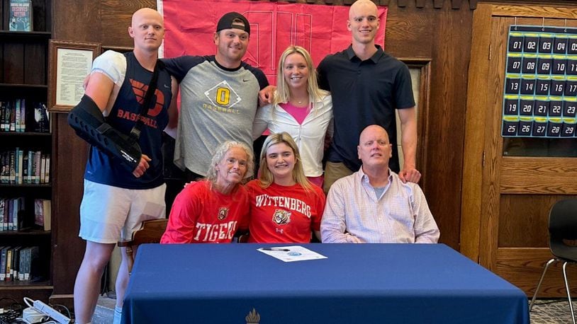 Emma Neff, signing to play basketball at Wittenberg University, while surrounded by her family. Flanking her in the front row are her mother Nancy and dad, Doug.., In the back row (left to right) are her siblings: Alex (who played baseball at Wright State and now the University of Dayton), Markus (who played baseball at Cedarville University) Kylie (a standout athlete at Oakwood) and Andy (Alex’s twin, who played basketball at Wright State.) CONTRIBUTED