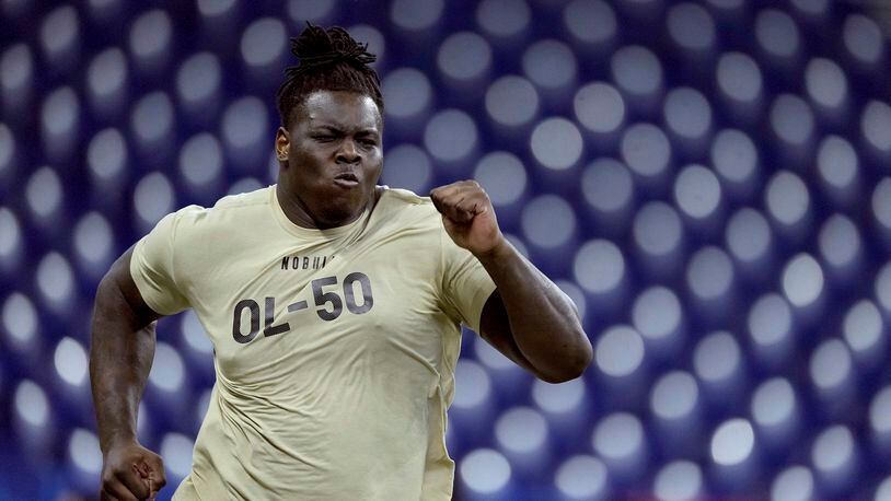 FILE - Georgia offensive lineman Amarius Mims runs the 40-yard-dash during the NFL football scouting combine March 3, 2024, in Indianapolis. The Cincinnati Bengals chose Mims in the first round of the NFL draft Thursday night, April 25. (AP Photo/Charlie Riedel, File)