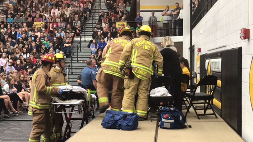 Washington Twp. firefighters play their roles in Centerville High School’s mock crash assembly April 27, 2017. TREMAYNE HOGUE / STAFF
