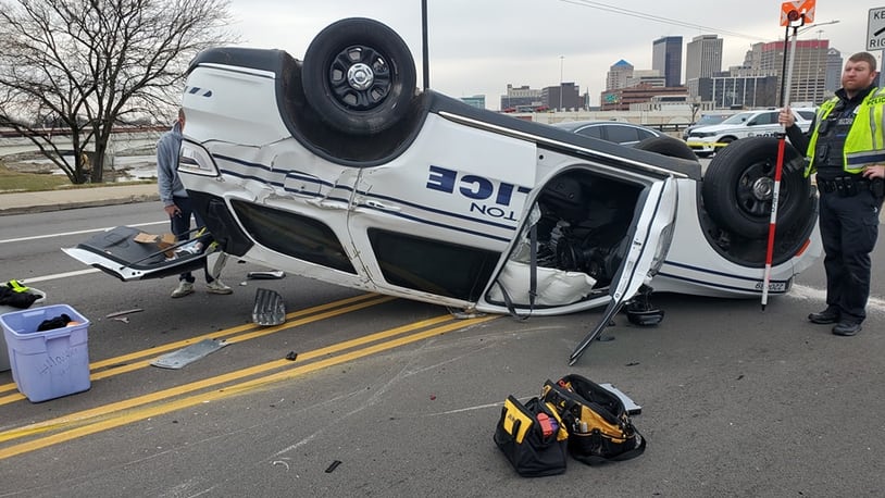 A Dayton Police Department cruiser flipped onto its top after another vehicles reportedly ran a red light and hit the cruiser at the intersection of First Street and Riverview Avenue. The officer was taken to the hospital with non-life-threatening injuries, according to police. Photo courtesy Dayton Police Department.