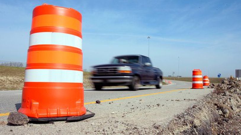 Motorists drive by orange barrels Monday, April 7, 2007 near the Ohio 129 on ramp to Interstate 75 in Westchester township in Butler County. Police have begun stepping up patrols in the construction areas of I-75. Staff photo by Gary Stelzer