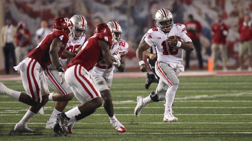 Ohio State's J.T. Barrett carries the ball against Indiana on Thursday, Aug. 31, 2017, at Memorial Stadium in Bloomington, Ind.