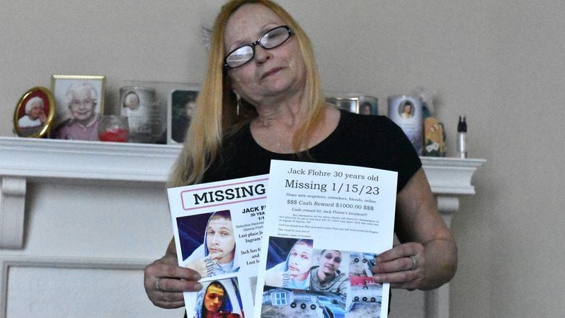 Glenna Flohre holds up missing posters for her son, Jack Flohre. Jack Flohre has not been seen since Jan. 15, 2023. His mother and a friend fear he may be dead or he's being held against his will. CORNELIUS FROLIK / STAFF
