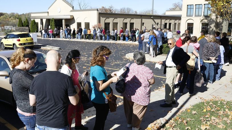 A line of voters stretches out the door and around the parking lot of the Clark County Board of Elections as people wait for over an hour to cast their vote Monday before early voting closes at 2p.m. Bill Lackey/Staff