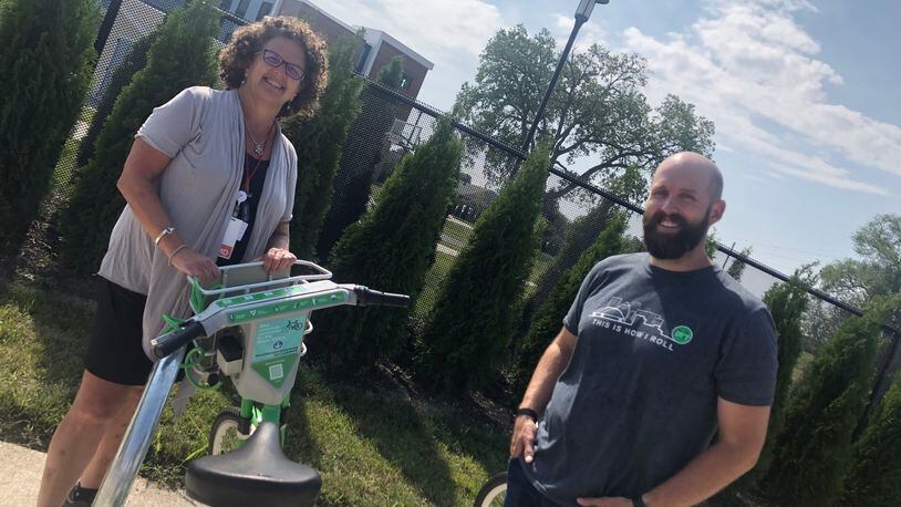 OneFifteen physician Leslie Dye and Bike Miami Valley business development manager Chris Buck check out the Link bikes after a recent cycling safety class - Contributed