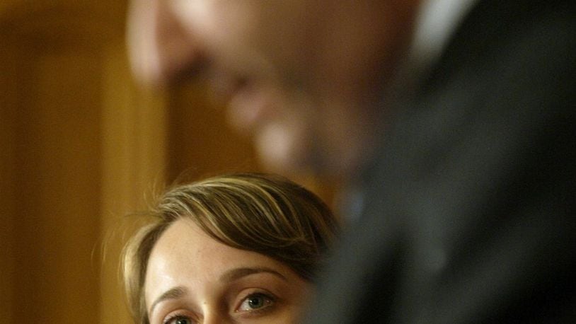 Mavilya Chubarova, a woman who former Attorney General Marc Dann raised as a daughter, watches as Dann resigns Wednesday May 14, 2008, in Columbus. Dann is one of the public officials in Ohio who has run afoul of the state’s ethics laws. LISA POWELL/STAFF