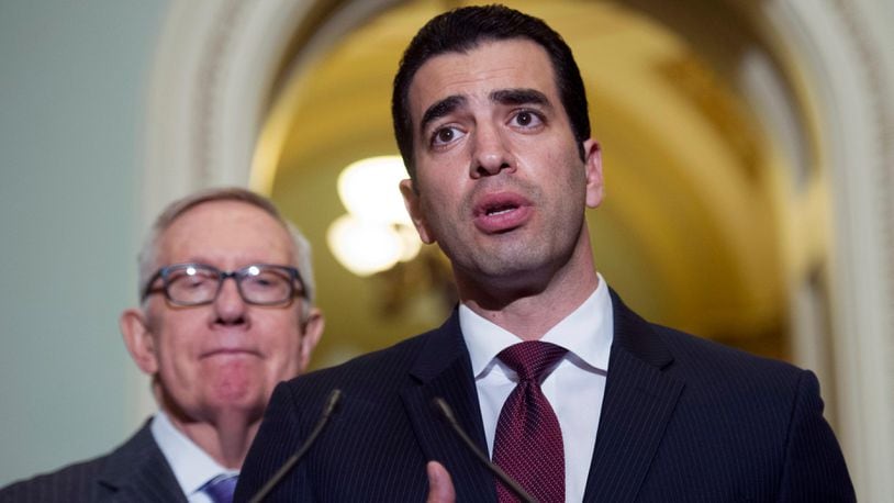 This Nov. 14, 2016 file photo Rep.-elect Ruben Kihuen, D-Nev.,right, speaks with reporters as Sen. Harry Reid, D-Nev., left, listens on Capitol Hill in Washington. The chairman of the House Democrats' campaign committee called on Kihuen to step down after a report Friday, Dec. 1, 2017, that he allegedly sexually harassed his campaign's finance director. (AP Photo/Cliff Owen,File)