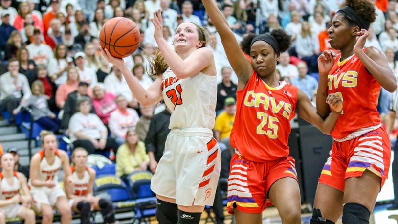 Waynesville High School senior Rachel Murray drives to the hoop against Purcell Marian’s Jaimone Jones (25) and Sha’Dai Hale (32) during a 2019 Division III regional final game. CONTRIBUTED PHOTO BY MICHAEL COOPER