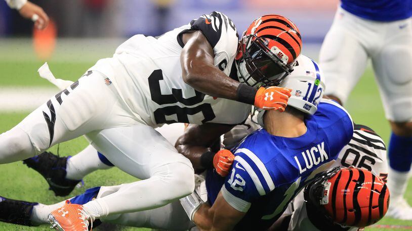 INDIANAPOLIS, IN - SEPTEMBER 09: Andrew Luck #12 of the Indianapolis Colts is taken down by Darius Phillips #38 and Michael Johnson #90 of the Cincinnati Bengals at Lucas Oil Stadium on September 9, 2018 in Indianapolis, Indiana. (Photo by Andy Lyons/Getty Images)