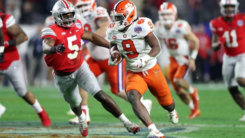 GLENDALE, ARIZONA - DECEMBER 28:  Travis Etienne #9 of the Clemson Tigers carries the ball for a 53-yard touchdown reception against the Ohio State Buckeyes in the second half during the College Football Playoff Semifinal at the PlayStation Fiesta Bowl at State Farm Stadium on December 28, 2019 in Glendale, Arizona. (Photo by Matthew Stockman/Getty Images)