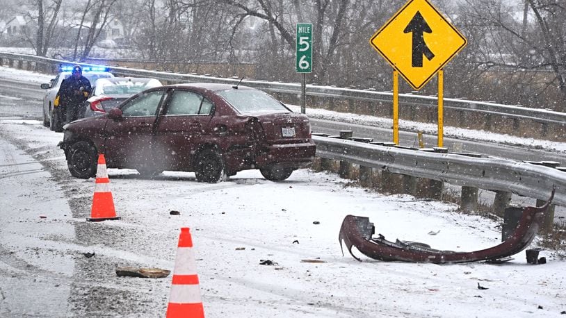 A car slides into a guardrail along northbound I-75 near Stanley Avenue Monday morning, February 15, 2021. MARSHALL GORBY/STAFF