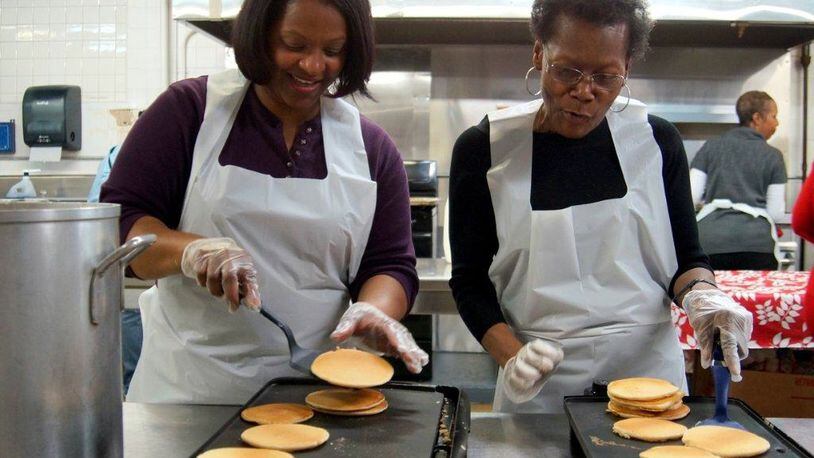 Volunteers at last year’s Day of Caring kept the pancakes coming. CONTRIBUTED