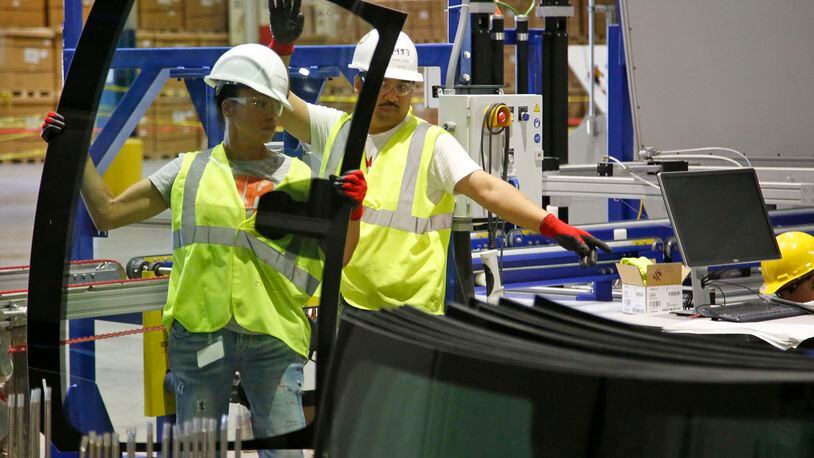 Workers in the Fuyao Glass America Moraine plant hard at work, stacking newly manufactured windshields. According to personal finances web site WalletHub, Dayton isn’t among the hardest working cities in America. TY GREENLEES / STAFF