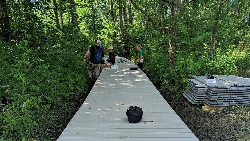 Volunteers with the Beaver Creek Wetlands Association work on constructing the next section of the Spotted Turtle Trail in Beavercreek. CONTRIBUTED