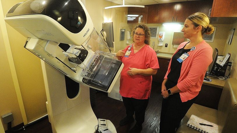 Shelly Robinson, mammographer for Premier Health mobile mammography coach, left, and Tracy Short, director of Premier Health's ambulatory imaging center, talk about the importance of Breast Cancer Awareness. MARSHALL GORBY\STAFF 