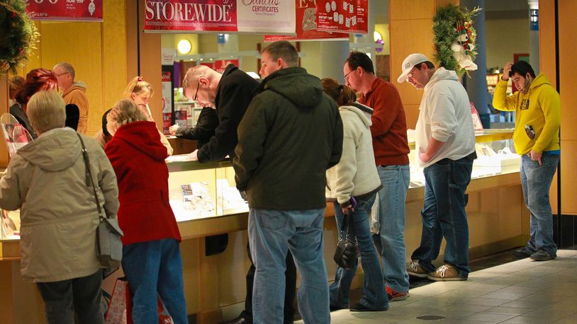 Shoppers look at inventory Monday afternoon at a busy Kay Jewelers at the Dayton Mall.