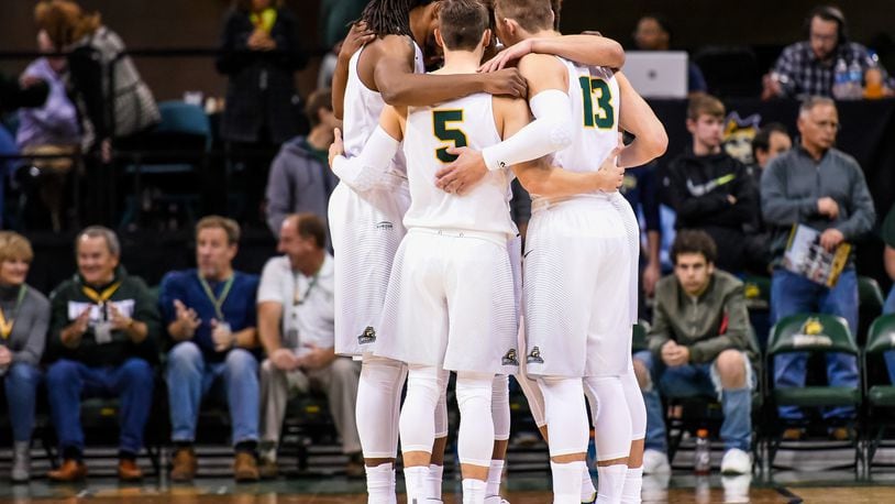 Wright State University Raiders team huddles before they defeated the Miami University Redhawks 89-87 Tuesday, Nov. 15 at Wright State University’s Nutter Center in Fairborn. NICK GRAHAM/STAFF