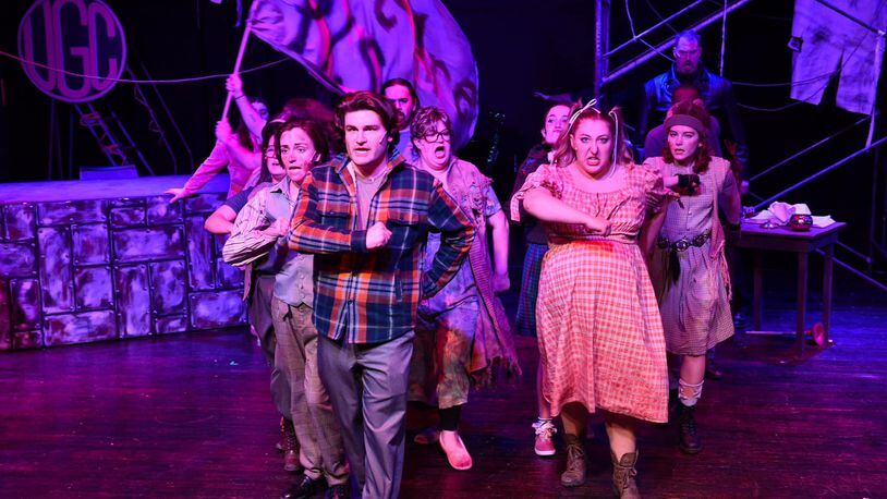 Garrett Young (center as Bobby Strong) and the cast of TheatreLab Dayton's production of "Urinetown." PHOTO BY MACKENSIE KING