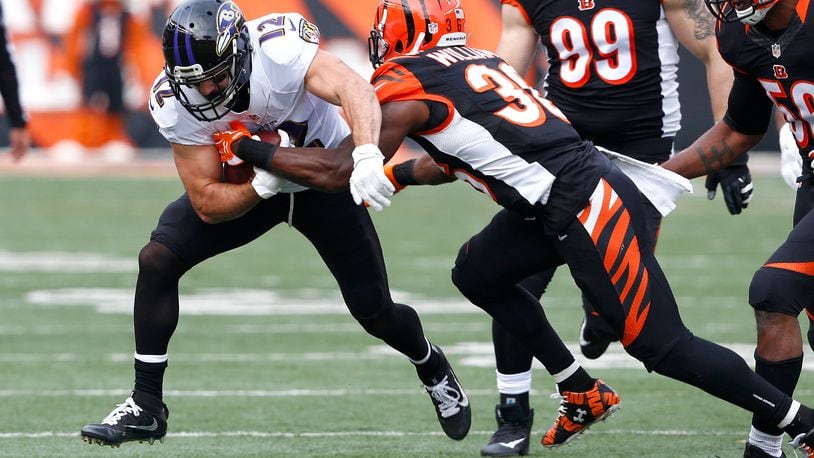 Michael Campanaro of the Ravens is tackled by Bengals strong safety Shawn Williams in the last game of the 2016 season, a 27-10 Cincinnati win in Paul Brown Stadium.