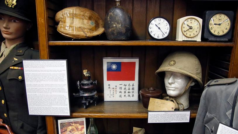 WWII artifacts, including a Japanese helmet, lower right, at the Miami Valley Military History Museum located in Building 120 on the Dayton Veterans Administration campus. TY GREENLEES / STAFF