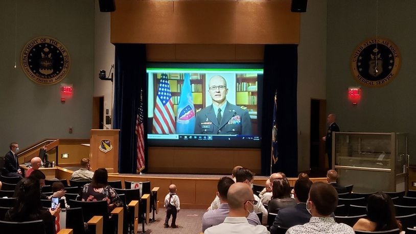Lt. Gen. Ronald J. Place, director, Defense Health Agency, speaks with graduates and attendees via video call in the 88th Medical Group auditorium at the Wright-Patterson Medical Center. (Contributed photo)
